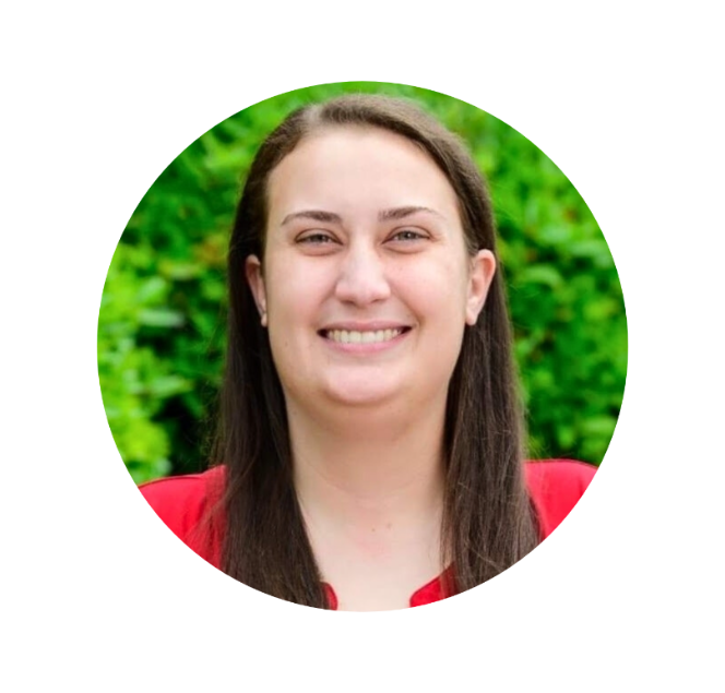 a headshot of carolina neurodiversity center's chief executive officer and founder, Emily Walsh. Emily is a white woman with medium length brown hair and she is wearing a red shirt.